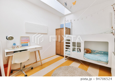 Minimalist interior of study room with parquet floor and white walls furnished with settee and table with shelf rack 94706524
