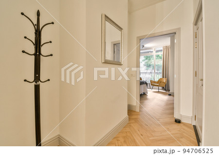 Comfortable bed located near balcony door with curtains in cozy light bedroom at home Comfortable bed located near balcony door with curtains in cozy light bedroom at home 94706525