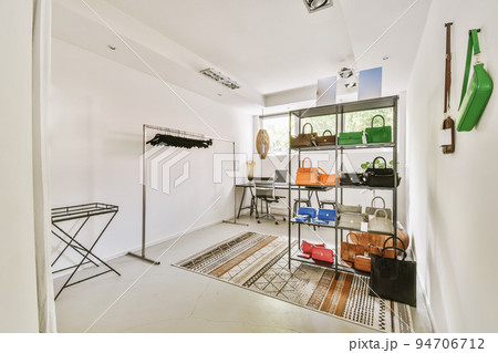 Comfortable chair placed near desk with computer monitors and whiteboard in light workplace in modern apartment Comfortable chair placed near desk with computer monitors and whiteboard in light workplace in modern apartment 94706712