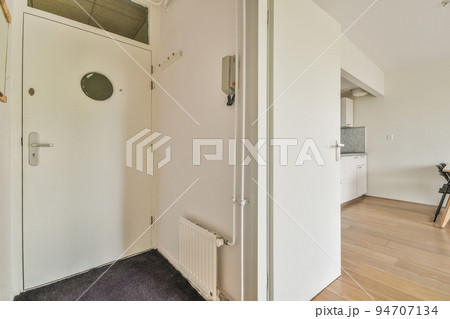 Interior of narrow corridor with telephone in daylight Interior of narrow corridor with telephone in daylight 94707134