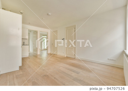 Contemporary counters and stools located under stylish exhaust hood in spacious light kitchen at home Contemporary counters and stools located under stylish exhaust hood in spacious light kitchen at home 94707526