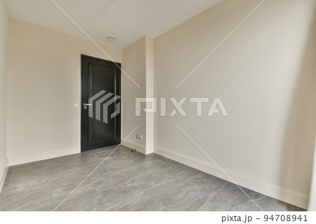 Spacious bright white empty room with glass door and gray curtain Spacious bright white empty room with glass door and gray curtain 94708941