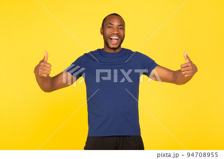 Joyful African American Man Gesturing Thumbs Up On Yellow Background 94708955