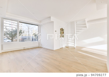 Plastic window and radiator on white wall in empty light room at home Plastic window and radiator on white wall in empty light room at home 94709277
