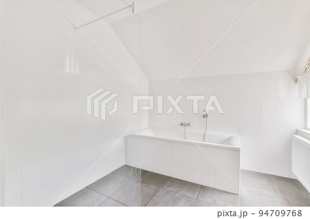 Sink with tap and liquid soap hanging on tiled wall under mirror in contemporary restroom at home Sink with tap and liquid soap hanging on tiled wall under mirror in contemporary restroom at home 94709768