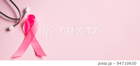 Breast Cancer Awareness Month. Pink ribbon and stethoscope on colored background. Women's health care concept. Symbol of fight against oncology. 94710630