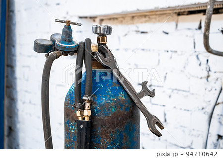 Old gas cylinders for welding and cutting. Rusty propane and oxygen tanks. Old gas cylinders for welding and cutting. Rusty propane and oxygen tanks. 94710642