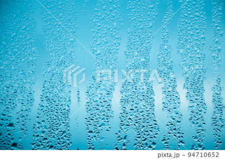 Texture of misted glass in autumn. Drops of water on window 94710652