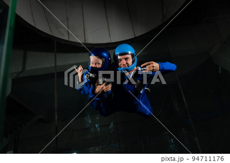 A man teaches a boy to fly in a wind tunnel. Lack of gravity. A man teaches a boy to fly in a wind tunnel. Lack of gravity. 94711176