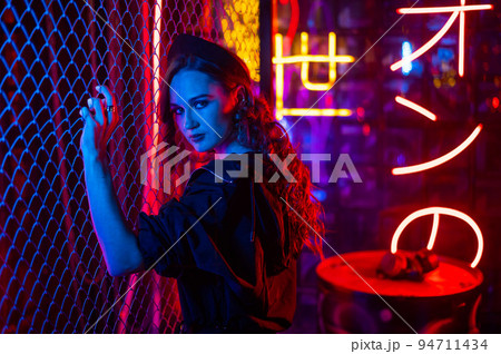 Caucasian woman posing in neon studio. Caucasian woman posing in neon studio. 94711434