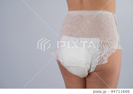 Rear view of a Woman in adult diapers on a white background. Incontinence problem.  94711606