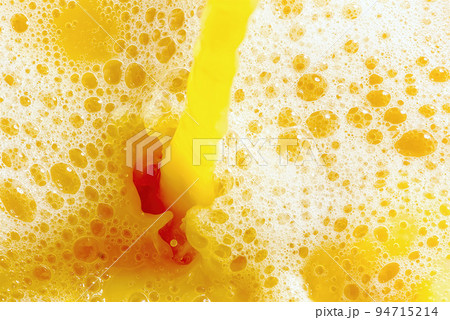 Closeup of splashing orange juice, top view. Splash of fresh sweet orange, mango, fruit juice. 94715214