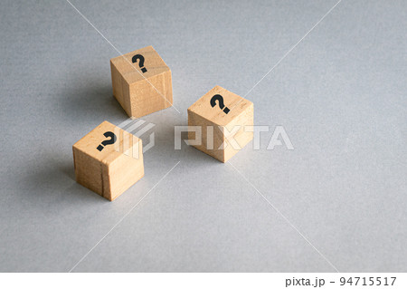 Wooden cube block shape with sign question mark on them. 94715517