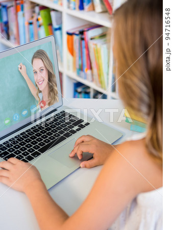 Female student having a videocall with female teacher on laptop at home Female student having a videocall with female teacher on laptop at home 94716548