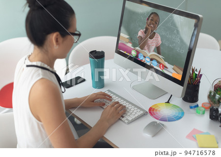 Female teacher having a videocall with female student on computer at home 94716578