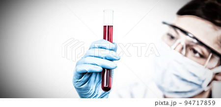 Female scientist conducting an experiment. Testing for Coronavirus pandemic 94717859