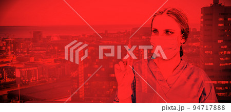 Composite image of pretty brunette female doctor holding a syringe and looking at it. Testing for Co Composite image of pretty brunette female doctor holding a syringe and looking at it. Testing for Co 94717888