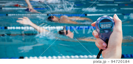 Composite image of close-up of a woman holding a chronometer to measure performance Composite image of close-up of a woman holding a chronometer to measure performance 94720184
