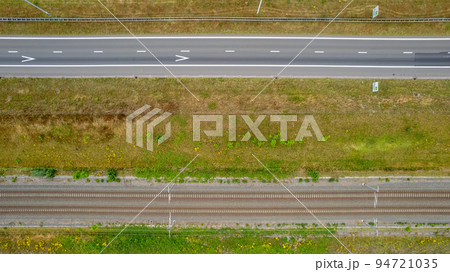 Aerial view of highway road junction. Highways, bridge and green fields on the outskirts of the city 94721035