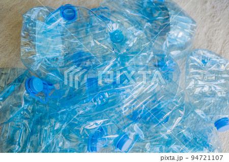 Large stack of old plastic bottles on the floor 94721107