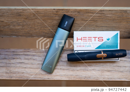 Tarragona, Spain - September 16, 2022: Electronic cigarettes IQOS close-up. Different options for smoking and cigarette. Choice of devices for the use of nicotine. Tarragona, Spain - September 16, 2022: Electronic cigarettes IQOS close-up. Different options for smoking and cigarette. Choice of devices for the use of nicotine. 94727442