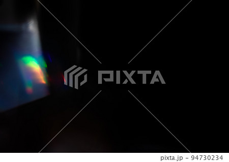 colorful rainbow crystal light leaks on black background 94730234