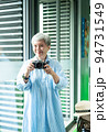 Portrait of happy senior adult elderly asia woman 60s taking pictures with photo camera for travel concept. 94731549