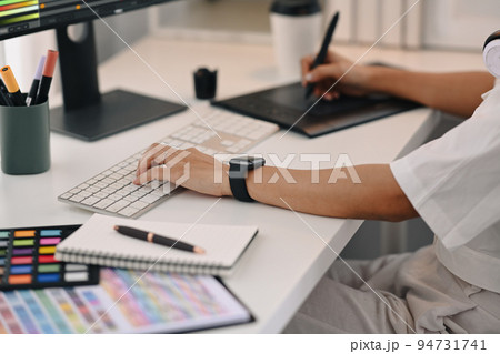 Cropped view of young creative woman using graphic tablet, working for design project at home office 94731741