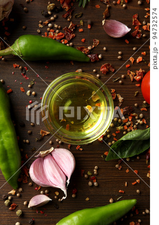Different cooking ingredients and spices on wooden background Different cooking ingredients and spices on wooden background 94732574
