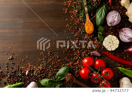 Different cooking ingredients and spices on wooden background Different cooking ingredients and spices on wooden background 94732577