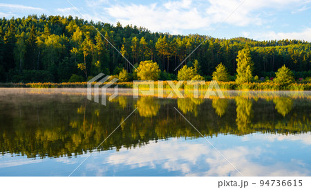 Idyllic sunny and hazy morning at the water Idyllic sunny and hazy morning at the water 94736615