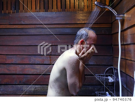 Asian man's showering in bathroom for clean a body and relax by bare and water drops from shower to the head and all body, Asian men bathing in the bathroom. Asian man's showering in bathroom for clean a body and relax by bare and water drops from shower to the head and all body, Asian men bathing in the bathroom. 94740376