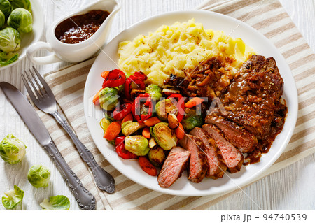 beef steak with potato mash and roasted vegetables 94740539