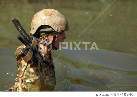 Special forces soldier with weapon take part in military maneuver. War, army, technology and people concept Special forces soldier with weapon take part in military maneuver. War, army, technology and people concept 94740940