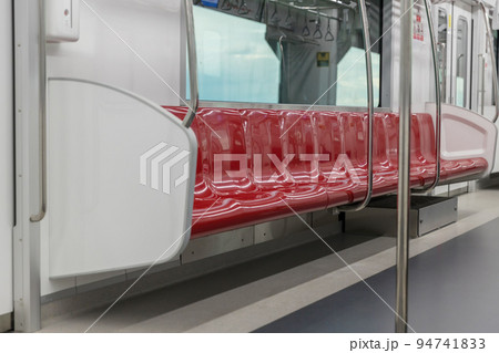 Empty seats commuter with Red color interior inside in the subway train. 94741833