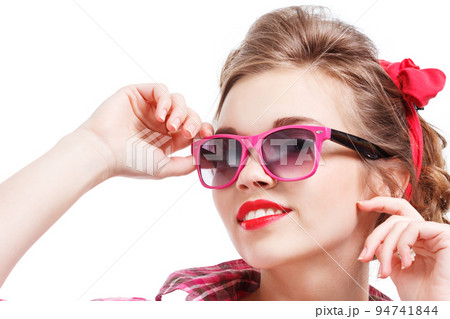 Coquettish girl in silk dress and glasses licks her finger and holds martini Coquettish girl in silk dress and glasses licks her finger and holds martini 94741844