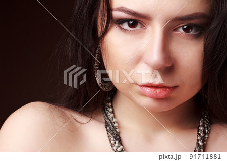 Sexy sensual lips. Glamorous portrait of a beautiful young model with sweet makeup, perfect skin, romantic wavy hair. With beautiful sexy big eyes. Makeup for a sunny date on Valentine's Day. 94741881