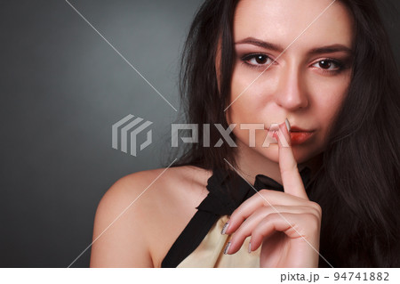 Sexy sensual lips. Glamorous portrait of a beautiful young model with sweet makeup, perfect skin, romantic wavy hair. With beautiful sexy big eyes. Makeup for a sunny date on Valentine's Day. Sexy sensual lips. Glamorous portrait of a beautiful young model with sweet makeup, perfect skin, romantic wavy hair. With beautiful sexy big eyes. Makeup for a sunny date on Valentine's Day. 94741882