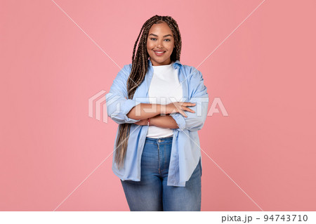 Smiling Overweight Lady Standing In Studio On Pink Background Smiling Overweight Lady Standing In Studio On Pink Background 94743710