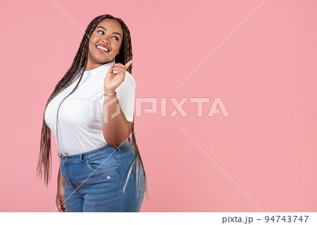 Pretty African American Obese Woman Pointing Finger Aside, Pink Background Pretty African American Obese Woman Pointing Finger Aside, Pink Background 94743747