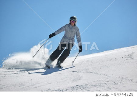 Skiing in the winter snowy slopes 94744529