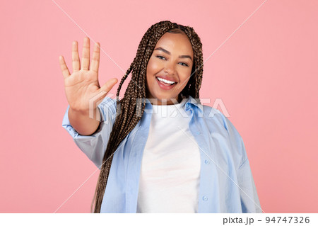 Happy Black Plus Size Woman Waving Hand On Pink Background 94747326