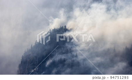 BC Forest Fire and Smoke over the mountain near Hope during a hot sunny summer day 94751293
