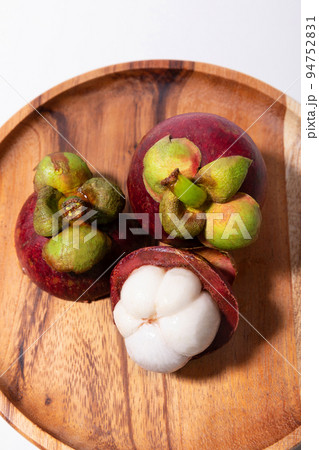 Tropical Fruits _Wooden plate and mangosteen 94752831