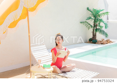 summer vacation concept_korean asian young woman reading a book on the sunbed 94753324