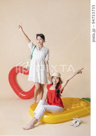 summer vacation trip with friends concept series_korean beautiful asian young women sitting on pool floats 94753735