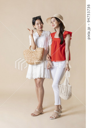 summer vacation trip with friends concept series_korean beautiful asian young women walking while pointing at the direction 94753736