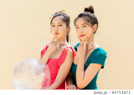 summer vacation trip with friends concept series_korean beautiful asian young women holding a pool float ball with hand motions 94753871