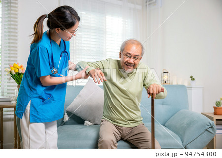 Young woman help support orthopedic patients to get up with walking cane at home Young woman help support orthopedic patients to get up with walking cane at home 94754300