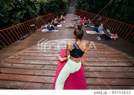 Group of young sporty people practicing yoga lesson with instructor, Group of young sporty people practicing yoga lesson with instructor, 94755623